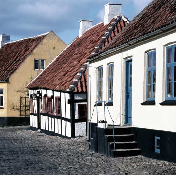 A long cobbled stone street lined with Danish traditional cottages in Ebeltoft, Denmark - Photo, image