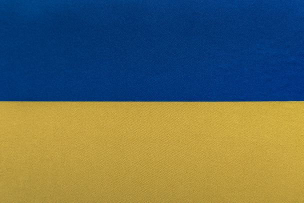 Ukrajna zászlója. Ukrajna nemzeti szimbólumai. Sárga kék zászló közelről. - Fotó, kép