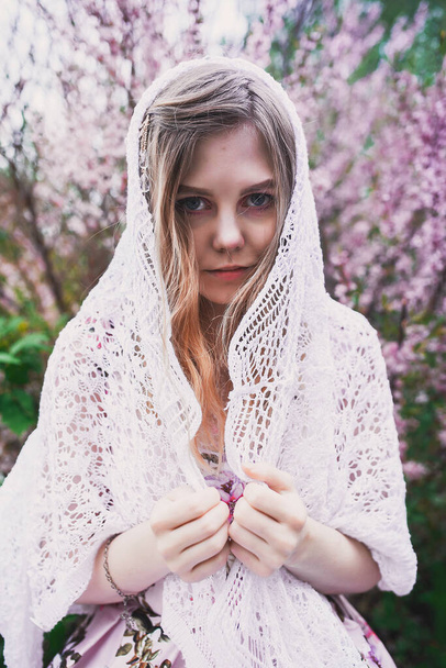 Girl in a delicate dress with mehendi on the body, in flowering almonds - Fotoğraf, Görsel
