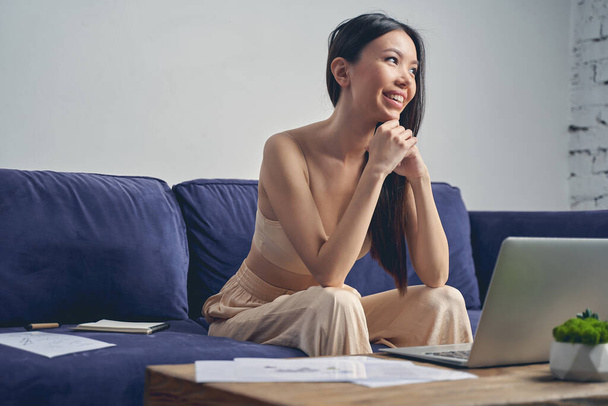 Cheerful lady using modern notebook at home - Foto, Imagem