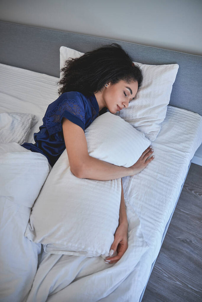 Young international female person embracing her pillow - Photo, image