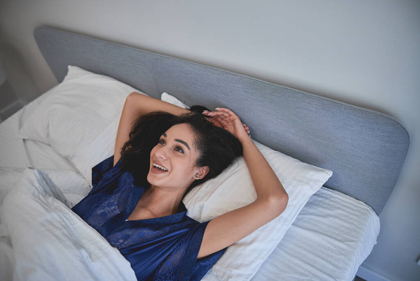 Positive delighted female person having rest at home - 写真・画像