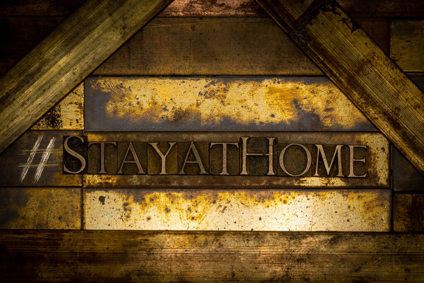 Zdjęcie autentycznych pism tworzących hashtag Stay At Home text on vintage textured grunge copper background - Zdjęcie, obraz