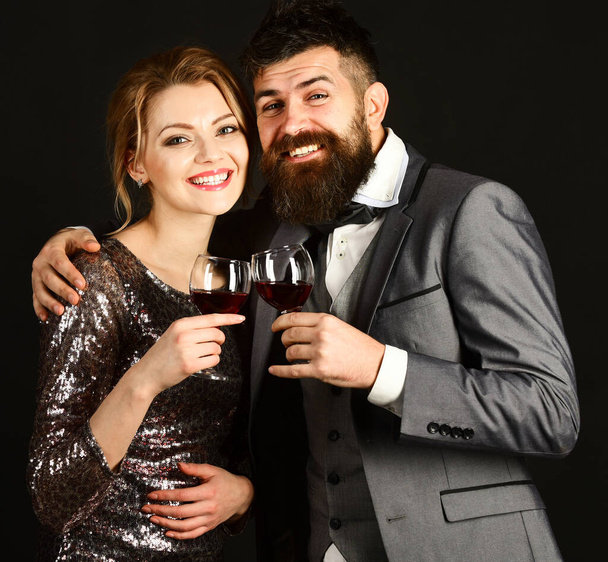 Man with beard and woman in shining dress celebrate - Foto, imagen