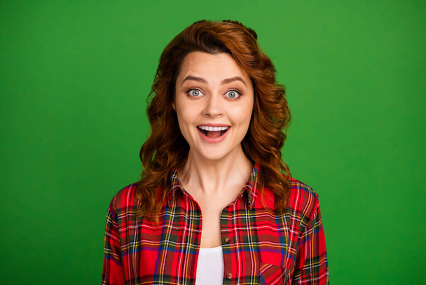 Close-up portrait of her she nice attractive lovely pretty amazed cheerful cheery wavy-haired girl wearing checked shirt great news isolated over bright vivid shine vibrant green color background - Valokuva, kuva