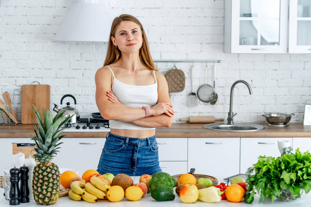 Dieting concept .Diet. Beautiful Young Woman near in the kitchen with healthy food. Fruits and Vegetables. - Foto, imagen