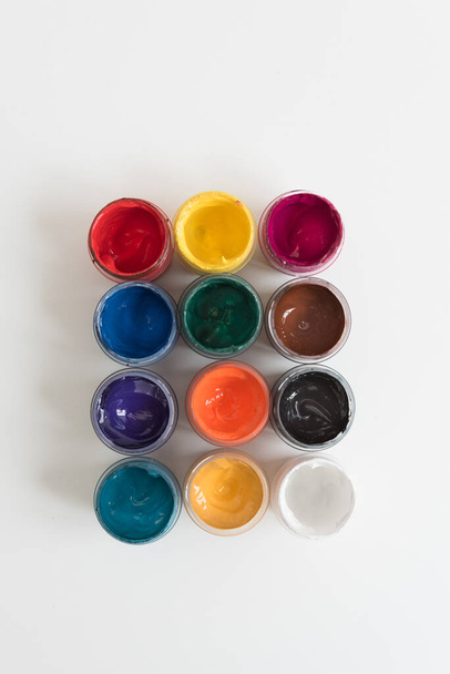 Open cans of paint, top view. Variety, many colors of gouache. texture. - Photo, image