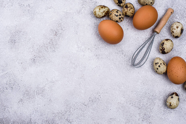 Chicken and quail eggs with whisk - Photo, Image