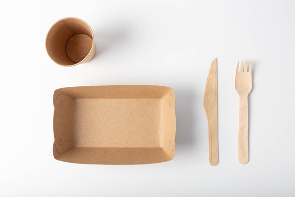Top view of eco packaging. A set of disposable organic crockery on a white background. - Fotó, kép