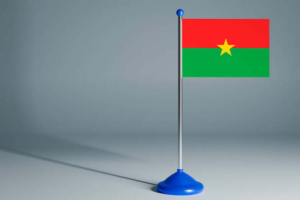 Die 3D-Darstellung der realistischen Nationalflagge von Burkino faso auf Stahlpfahl auf grauem isoliertem Hintergrund. Tischfahne blank, passend für Design, Mocku - Foto, Bild