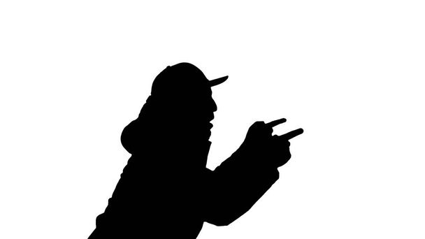 Silhueta Hip-hop homem cantando rap, andando e fazendo gestos
. - Foto, Imagem