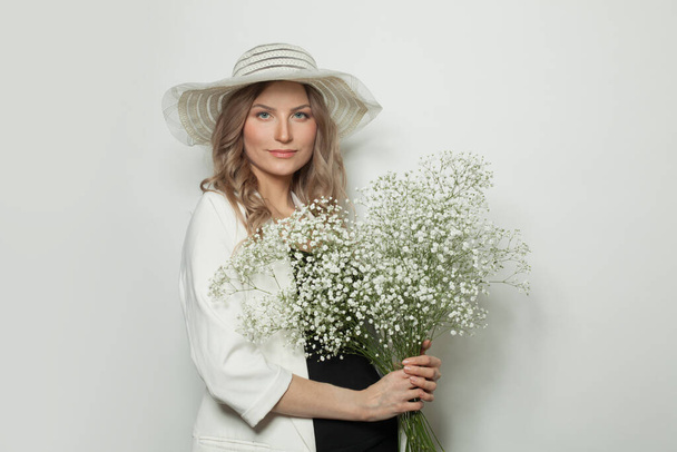 Vidám nő virágokkal fehér háttér - Fotó, kép