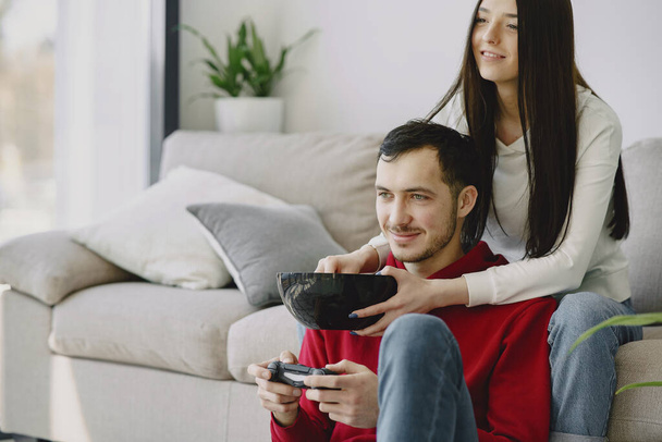 Couple at home playing in a video games - Foto, imagen