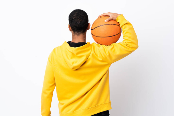 African American man over isolated white background playing basketball in back position - Foto, immagini