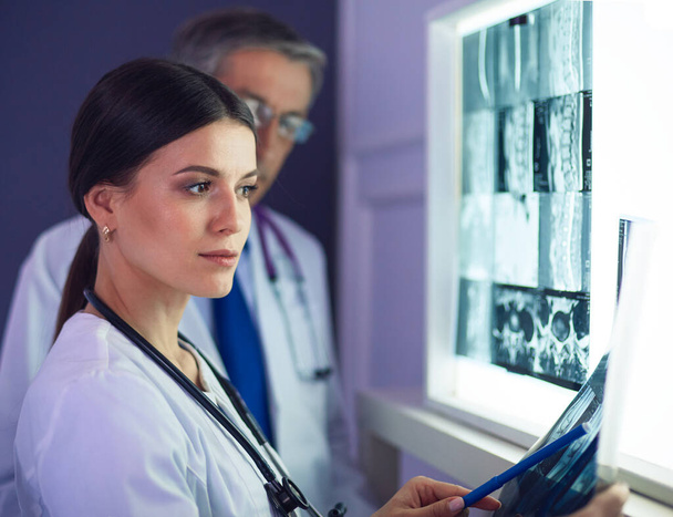 Hospital doctors looking at x-rays in an emergency room - Фото, зображення