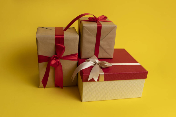 Gifts wrap gift paper on a yellow background - Foto, Imagem
