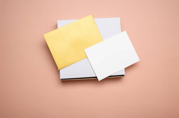 Envelope with a white sheet for text on a light background. View from above, place for text. - Fotografie, Obrázek