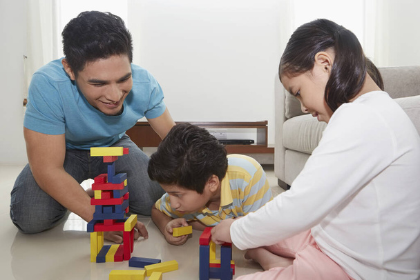 Cheerful father playing with his children - Photo, Image