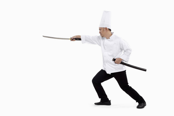 Asian chef with a samurai sword - Foto, afbeelding