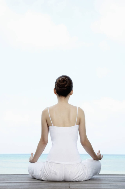 Woman meditating, back view - Foto, Imagem