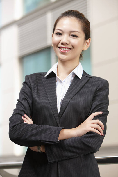 Businesswoman with arms across her chest - Photo, image