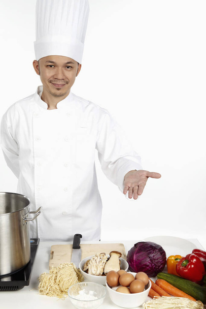 Asian chef preparing a wholesome meal - Foto, Imagen