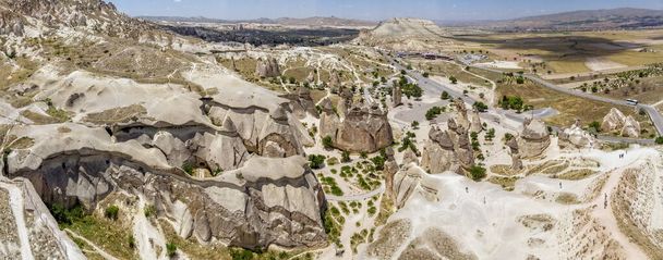 Aerial view of Goreme National Park, Goreme Tarihi Milli Parki, Turkey. The typical rock formations of Cappadocia with fairy chimneys and desert landscape. Travel destinations, holidays and adventure - Photo, Image