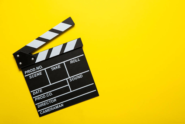 Movie clapper on a yellow background, top view. Place for text - Φωτογραφία, εικόνα