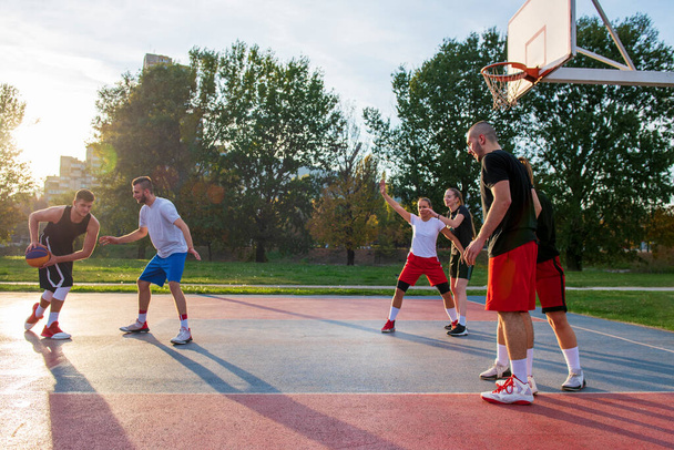 Group Of Young Friends Playing Basketball Match - Foto, immagini