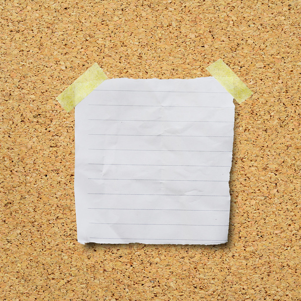 Blank torn paper with sticky on cork background - Foto, immagini