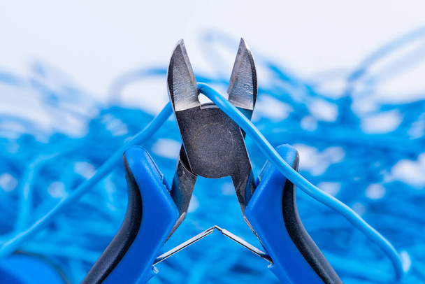 Manual tool pliers and electric cable, part of electrical installation - Photo, Image