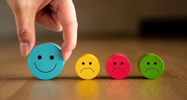 Customer service evaluation and satisfaction survey concepts. The client hand picked the happy face smile icon. - Photo, Image