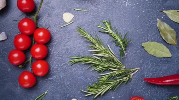 Frischer Rosmarin mit Gewürzen und Gemüse auf dunklem Hintergrund - Filmmaterial, Video
