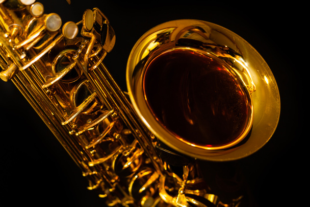 Golden saxophone on black background - 写真・画像