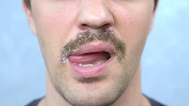 closeup mouth. hungry mustachioed man bites a hamburger - Materiał filmowy, wideo
