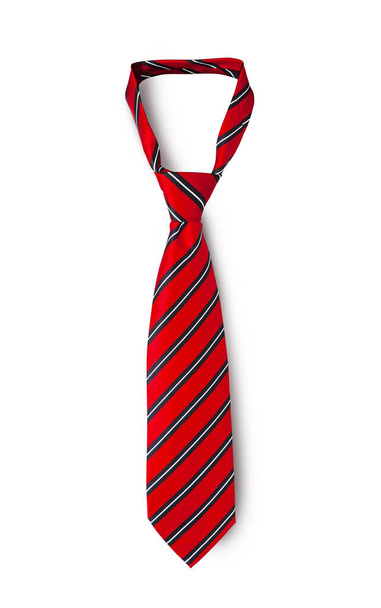 Red men's striped tie taken off for leisure time, isolated on white background. With clipping path. - Zdjęcie, obraz