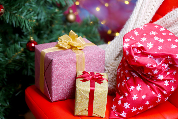 Christmas gift boxes on Christmas tree background - Zdjęcie, obraz