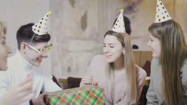 Smiling friends giving presents to thrilled birthday girl - Záběry, video
