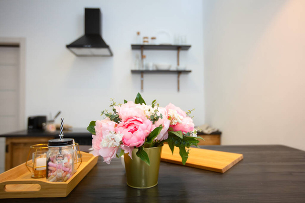 Keukentafel met bloemen en een dienblad. Prachtig keukeninterieur. - Foto, afbeelding