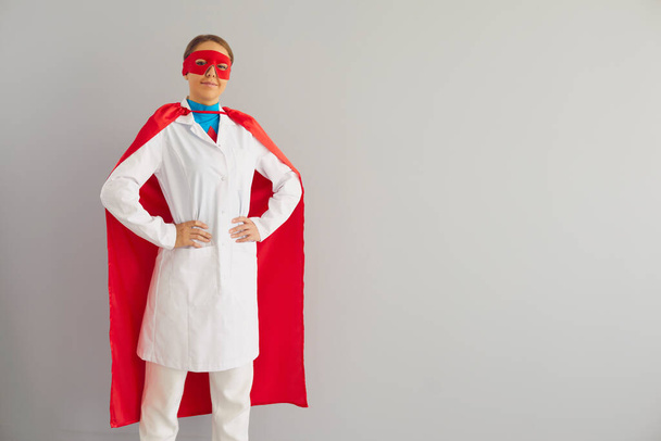 Doctor or nurse superhero on a gray background. - Fotoğraf, Görsel