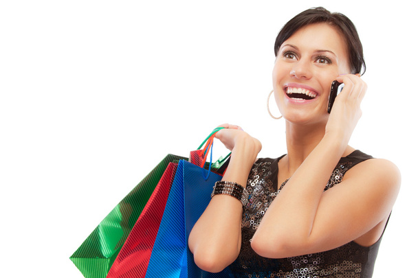 Очаровательная девушка с покупками говорит по телефону
 - Фото, изображение