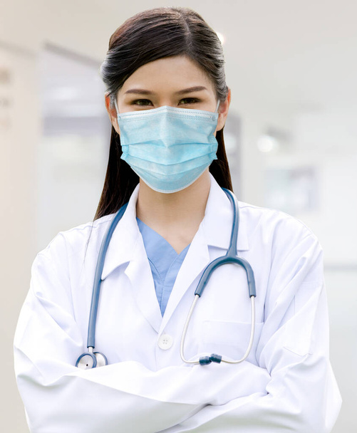 Doctor wear face mask in hospital protect from coronavirus disease or COVID-19. Medical staff are high risk people to receive infection from coronavirus disease or COVID-19. - Photo, Image