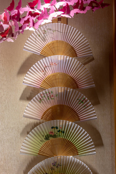 Traditional Chinese paper and bamboo folding hand fans, popular handmade souvenirs from China - Photo, Image