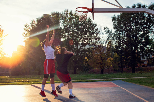woman basketball player have treining and exercise at basketball court at city on street - Foto, Bild