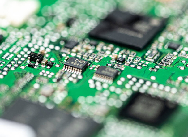 Green PCB (printed circuit board) close-up shot with a lot of electronic components - Zdjęcie, obraz