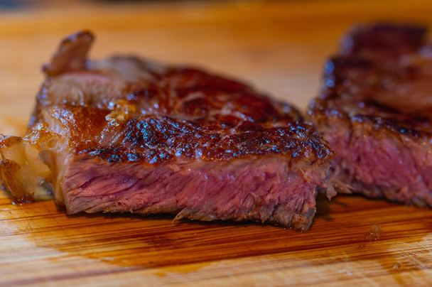 Shots of  a sliced fresh rump steak with fat on the steak on a wooden board - Photo, Image