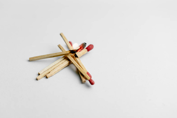 A close up shot of a flammable match stick stacked in a white background - Фото, изображение