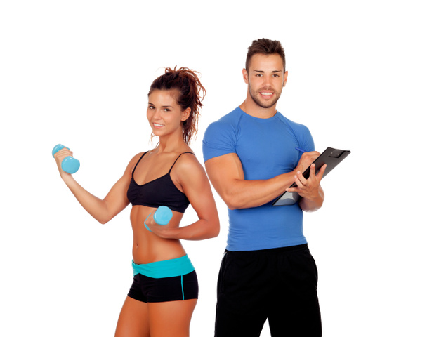 Handsome personal trainer with beautiful girl with dumbbells - Photo, Image