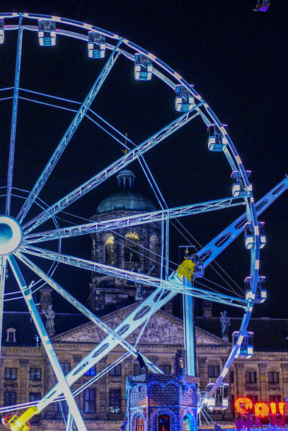 Ferris wheel and tower of the royal palace in Amsterdam - Photo, Image