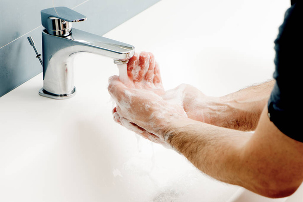 an washing hands with soap in the bathroom, cleaning operation - Φωτογραφία, εικόνα